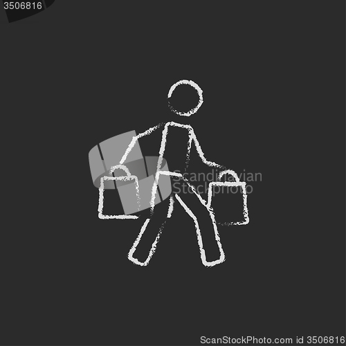 Image of Man carrying shopping bags icon drawn in chalk.