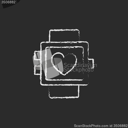 Image of Smartwatch with heart sign icon drawn in chalk.