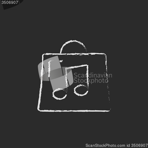 Image of Bag with music note icon drawn in chalk.