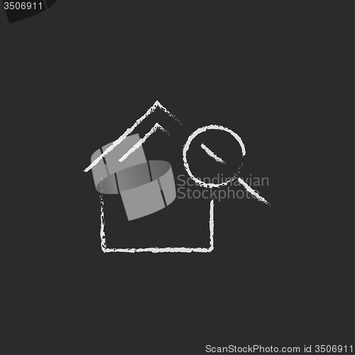 Image of House and magnifying glass icon drawn in chalk.