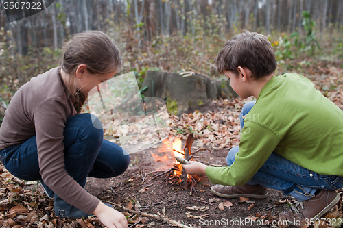 Image of Children starting a campfire