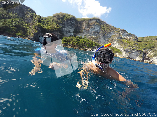 Image of shoot of a young boy snorkeling with father