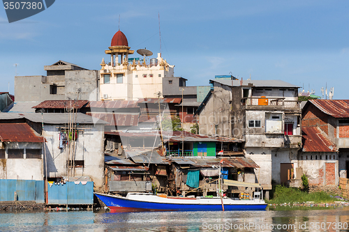 Image of Straw poor houses by the river