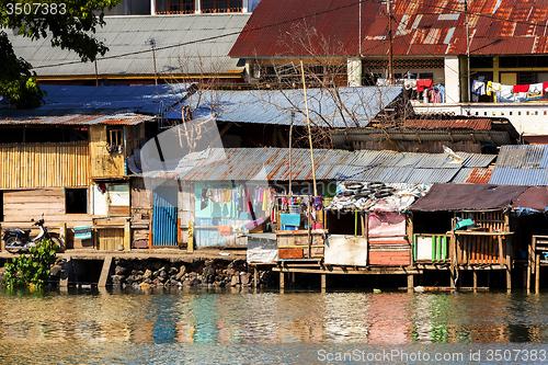 Image of Straw poor houses by the river