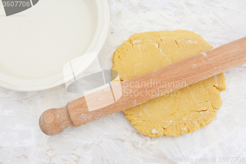 Image of Rolling out homemade pastry with a rolling pin