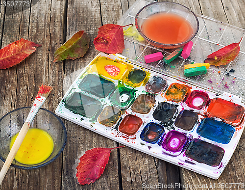 Image of Paint on the autumn table
