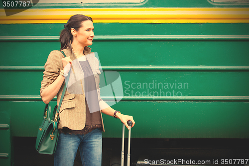 Image of beautiful adult woman with travel bag