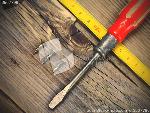 Image of Vintage screwdriver, screws and measuring lenght