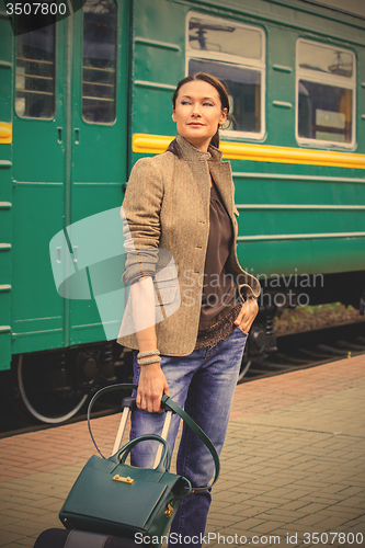 Image of woman with luggage returned from a retro travel