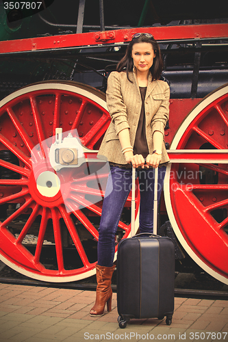 Image of Travel portrait of a beautiful adult woman with luggage