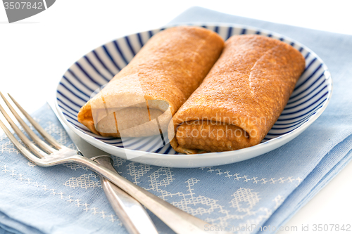 Image of Crepes stuffed with cottage cheese.