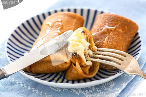 Image of Crepes with cottage cheese and honey.