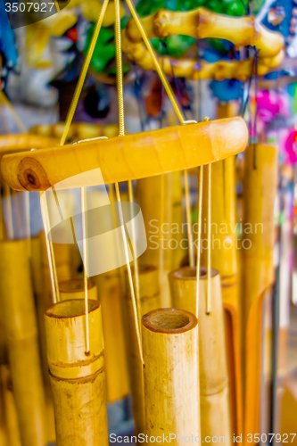 Image of wooden and other wind chimes on display