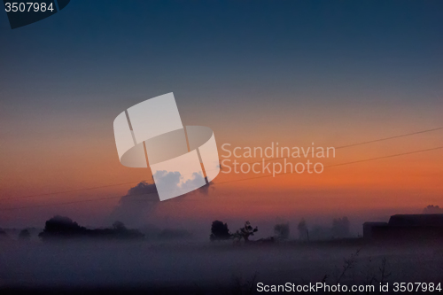 Image of early sunrise over foggy farm landscape in rock hill south carol