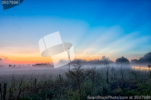 Image of early sunrise over foggy farm landscape in rock hill south carol