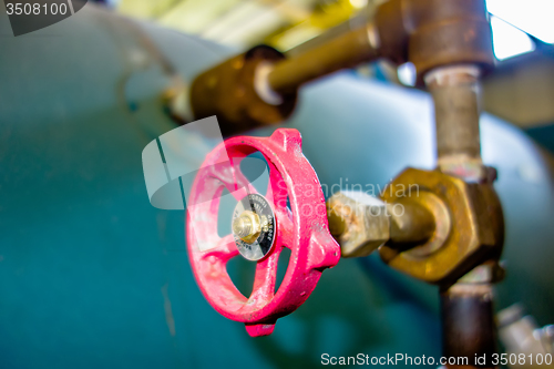 Image of various old boiler room pipe valves