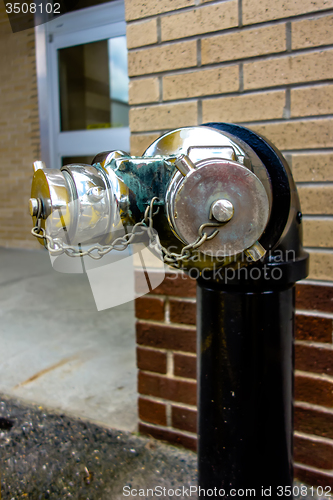 Image of standpipe with siamese connection device for fire hoses