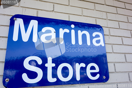 Image of boat marina store sign on brick masonry wall