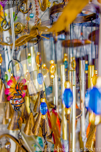 Image of wooden and other wind chimes on display