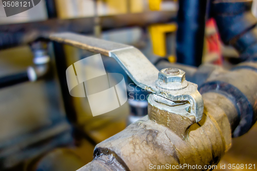 Image of various old boiler room pipe valves