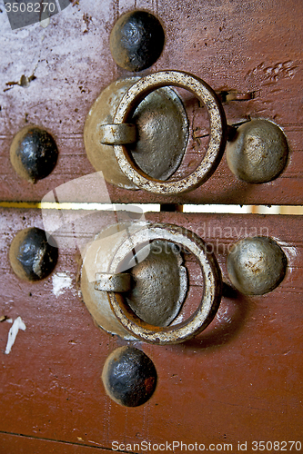 Image of   in africa the old wood  facade  and rusty safe padlock 