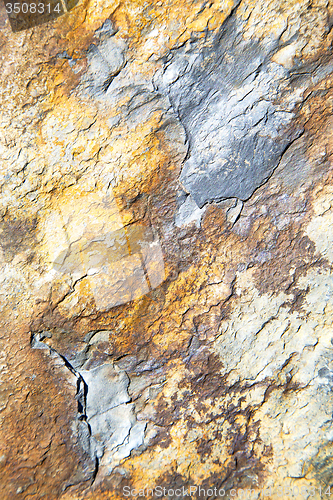 Image of rocks  and red orange gneiss in the wall of  