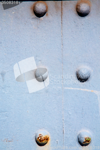 Image of blue   handle in  rusty  brass nail and light