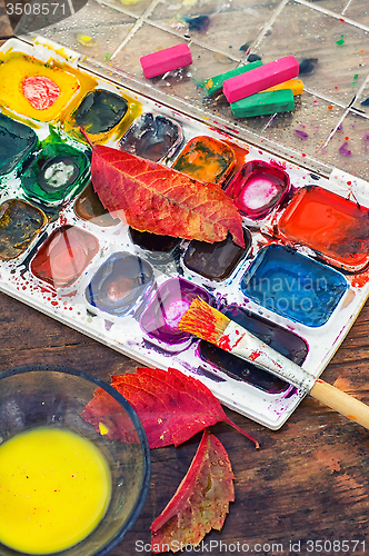 Image of Paint on the autumn table