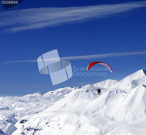 Image of Sky gliding in snowy mountains at nice sun day