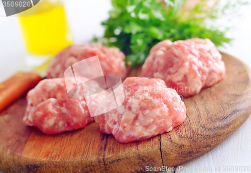 Image of Raw balls from meat on wooden background
