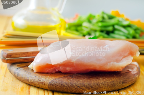 Image of Raw chicken on the wooden board, raw chicken and raw pasta