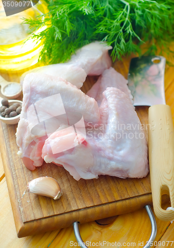 Image of Raw chicken on wooden board, Chicken Wings