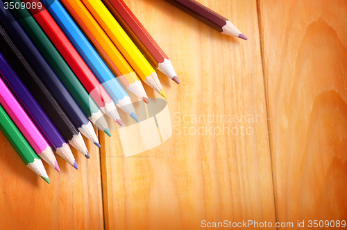 Image of color pencils on wooden background, school supplies