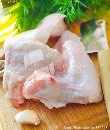 Image of Raw chicken on wooden board, Chicken Wings