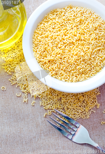 Image of Pasta - alphabet, raw italian pasta in bowl