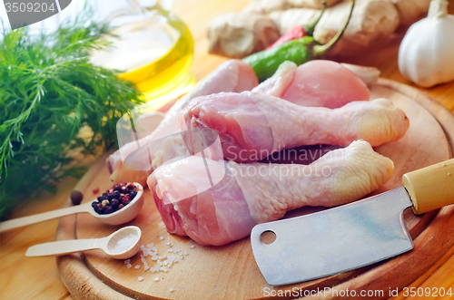 Image of Raw chicken on wooden board, Chicken with spice