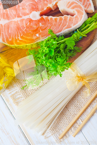 Image of raw rice noodles and raw salmon