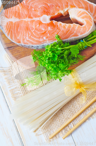 Image of raw rice noodles and raw salmon