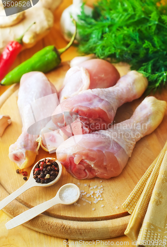 Image of Raw chicken on wooden board, Chicken with spice