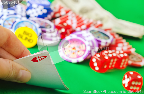 Image of Card for poker in the hand, chips and card for poker