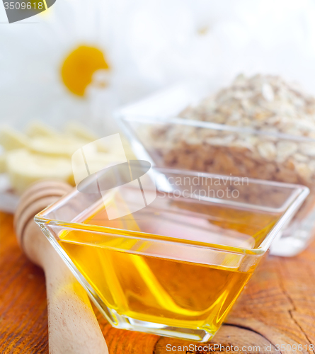 Image of Honey in the glass bowl on the wooden table