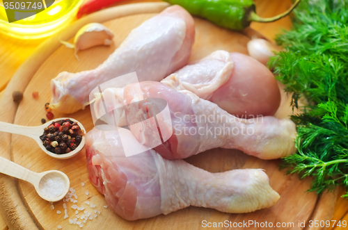 Image of Raw chicken on wooden board, Chicken with spice