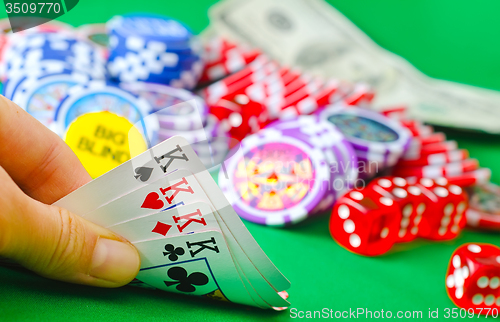 Image of Card for poker in the hand, chips and card for poker