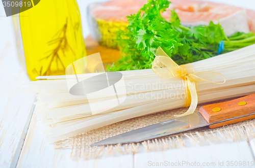 Image of raw rice noodles and raw salmon