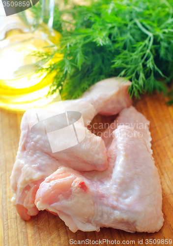 Image of Raw chicken on wooden board, Chicken Wings