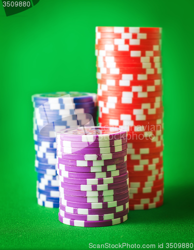 Image of Group from chips for poker on the green background