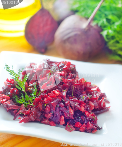 Image of Fresh salad with beet and walnuts on white plate