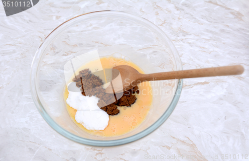 Image of Stirring caster and muscovado sugar into beaten egg