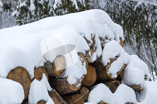 Image of Snow covered stack of wood