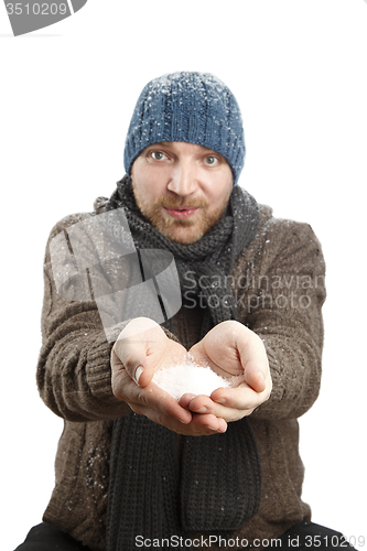 Image of Portrait of an attractive man with snow in his hands